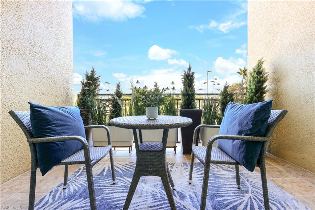 9115 Strada Place, Unit 5205 Naples, FL 34108 - Photo 11 of 36 a view of a chairs and table in the patio