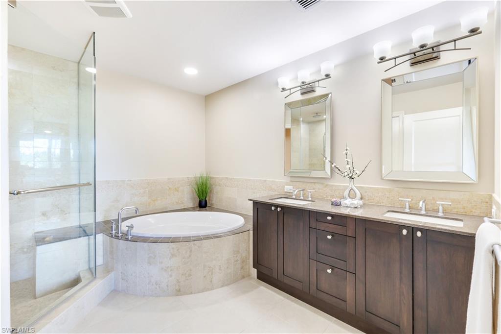 9115 Strada Place, Unit 5205 Naples, FL 34108 - Photo 14 of 36 a bathroom with a double vanity sink mirror and toilet