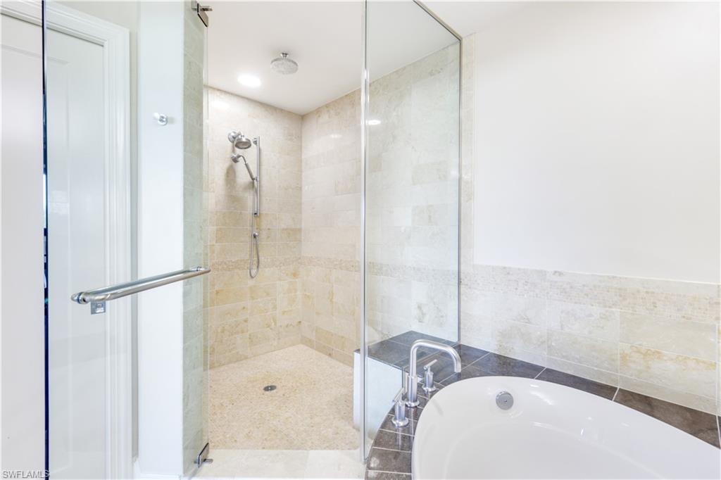 9115 Strada Place, Unit 5205 Naples, FL 34108 - Photo 15 of 36 a bathroom with a sink and a shower