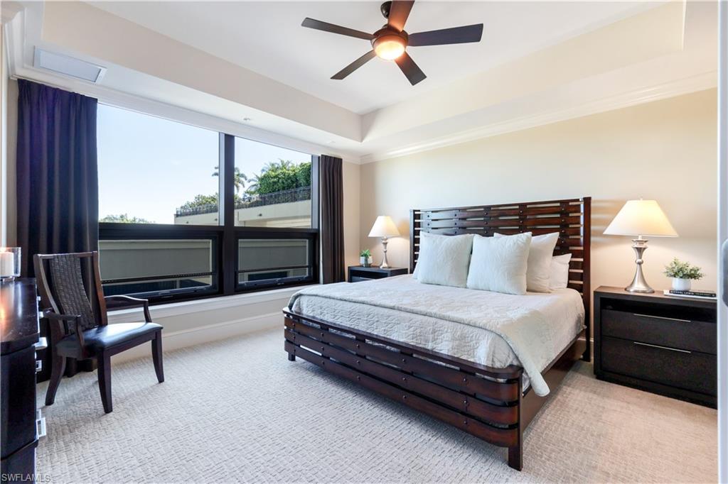 9115 Strada Place, Unit 5205 Naples, FL 34108 - Photo 16 of 36 a spacious bedroom with a bed and large window