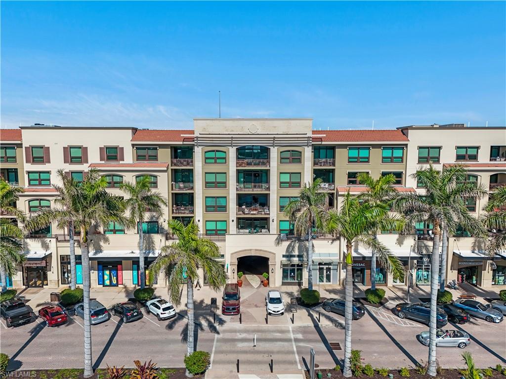 9115 Strada Place, Unit 5205 Naples, FL 34108 - Photo 20 of 36 front view of a building with a garden