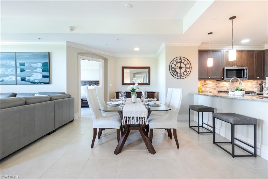 9115 Strada Place, Unit 5205 Naples, FL 34108 - Photo 4 of 36 a living room with furniture and a large window