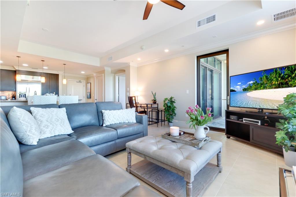 9115 Strada Place, Unit 5205 Naples, FL 34108 - Photo 6 of 36 a living room with furniture and a flat screen tv