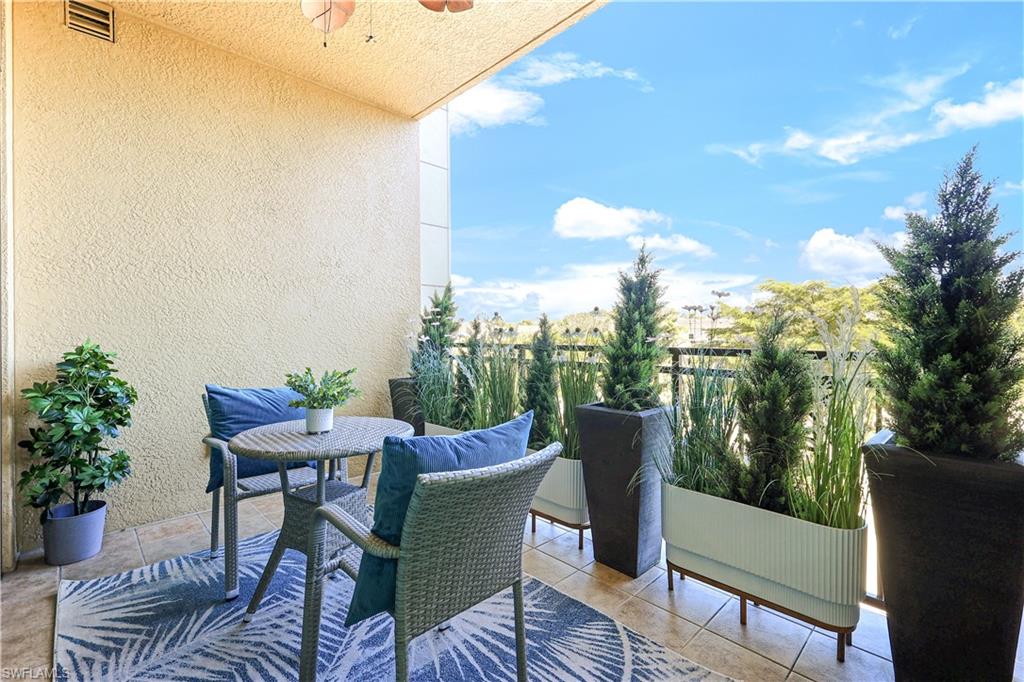 9115 Strada Place, Unit 5205 Naples, FL 34108 - Photo 7 of 36 a view of a chairs and table in the patio