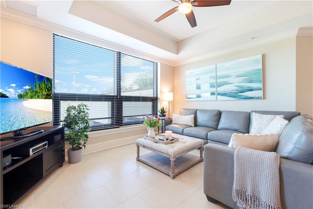 9115 Strada Place, Unit 5205 Naples, FL 34108 - Photo 9 of 36 a living room with furniture and a flat screen tv