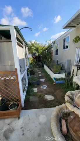 a room with patio furniture and a potted plant
