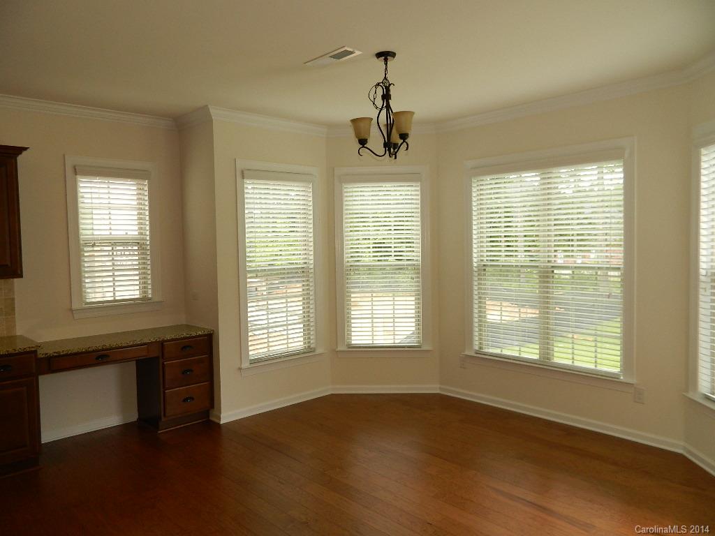 535 Brookhaven Drive, Unit HC77 Fort Mill, SC 29708 - Photo 4 of 10 a view of an empty room with wooden floor and a window