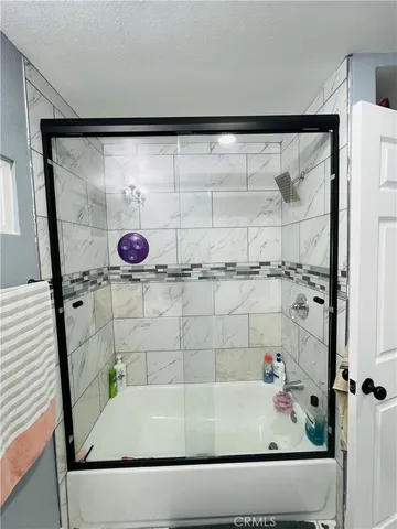 a bathroom with a bathtub and shower