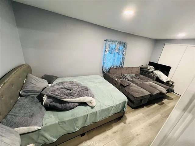 a bedroom with bed and a couch