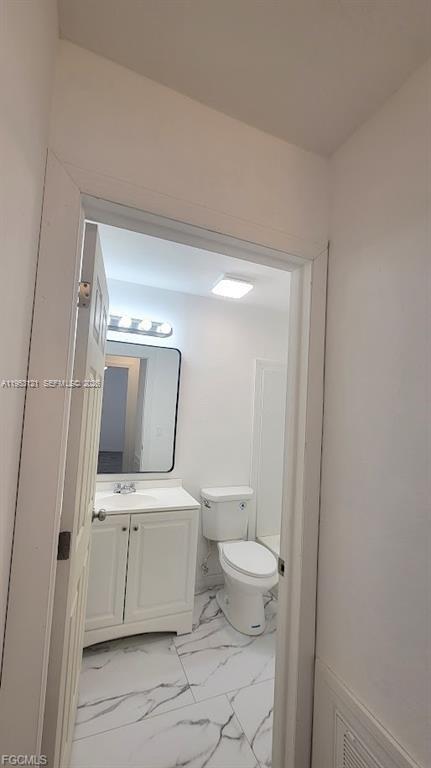 4008 Rye Court LaBelle, FL 33935 - Photo 11 of 12 a bathroom with a toilet a sink and mirror