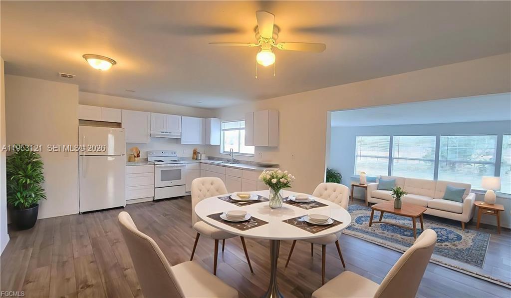 4008 Rye Court LaBelle, FL 33935 - Photo 5 of 12 a view of a dining room with furniture and wooden floor