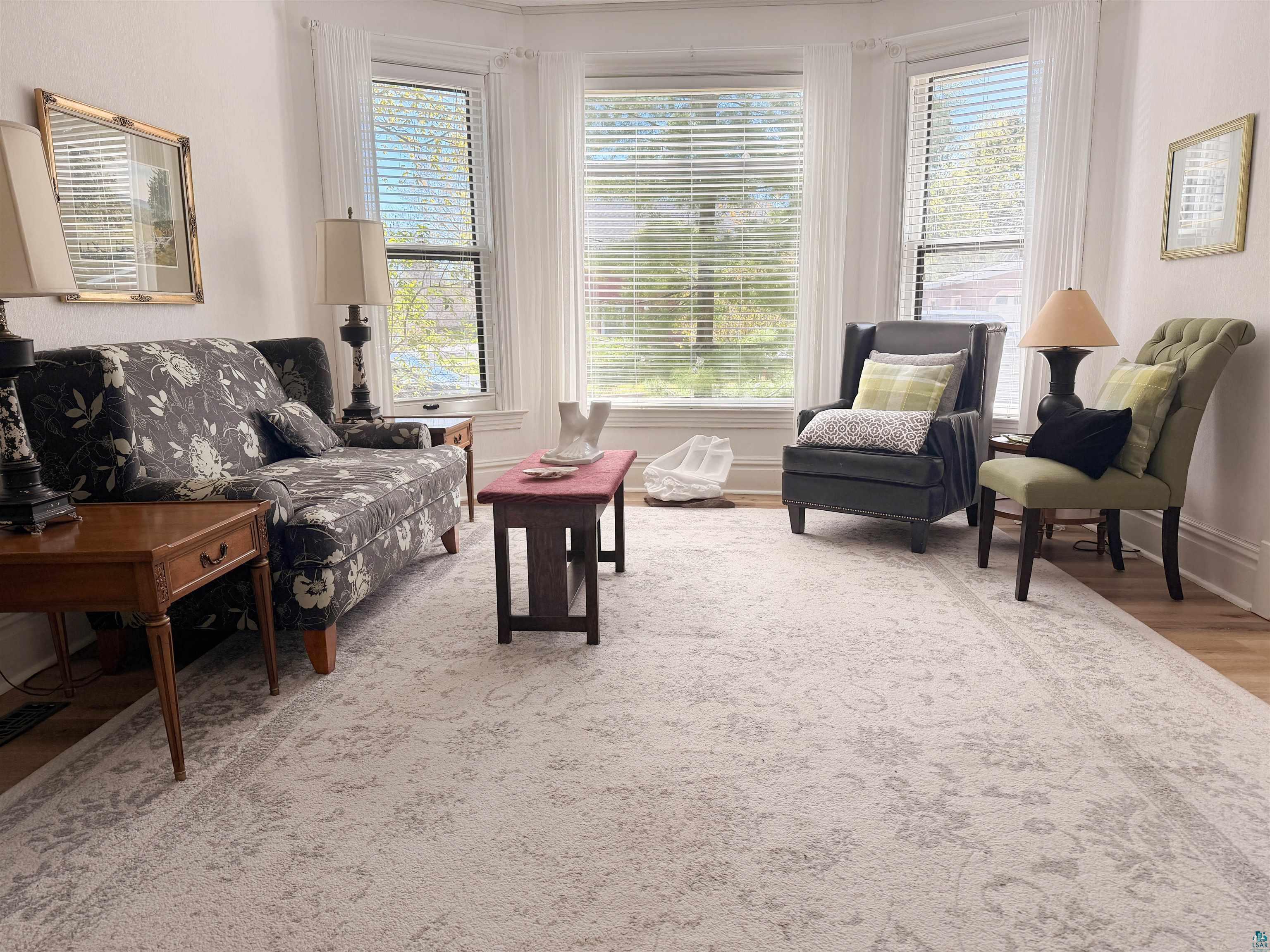 303 East 5th Street Washburn, WI 54891 - Photo 21 of 34 Bay window with multiple large windows featuring horizontal blinds and white sheer curtains