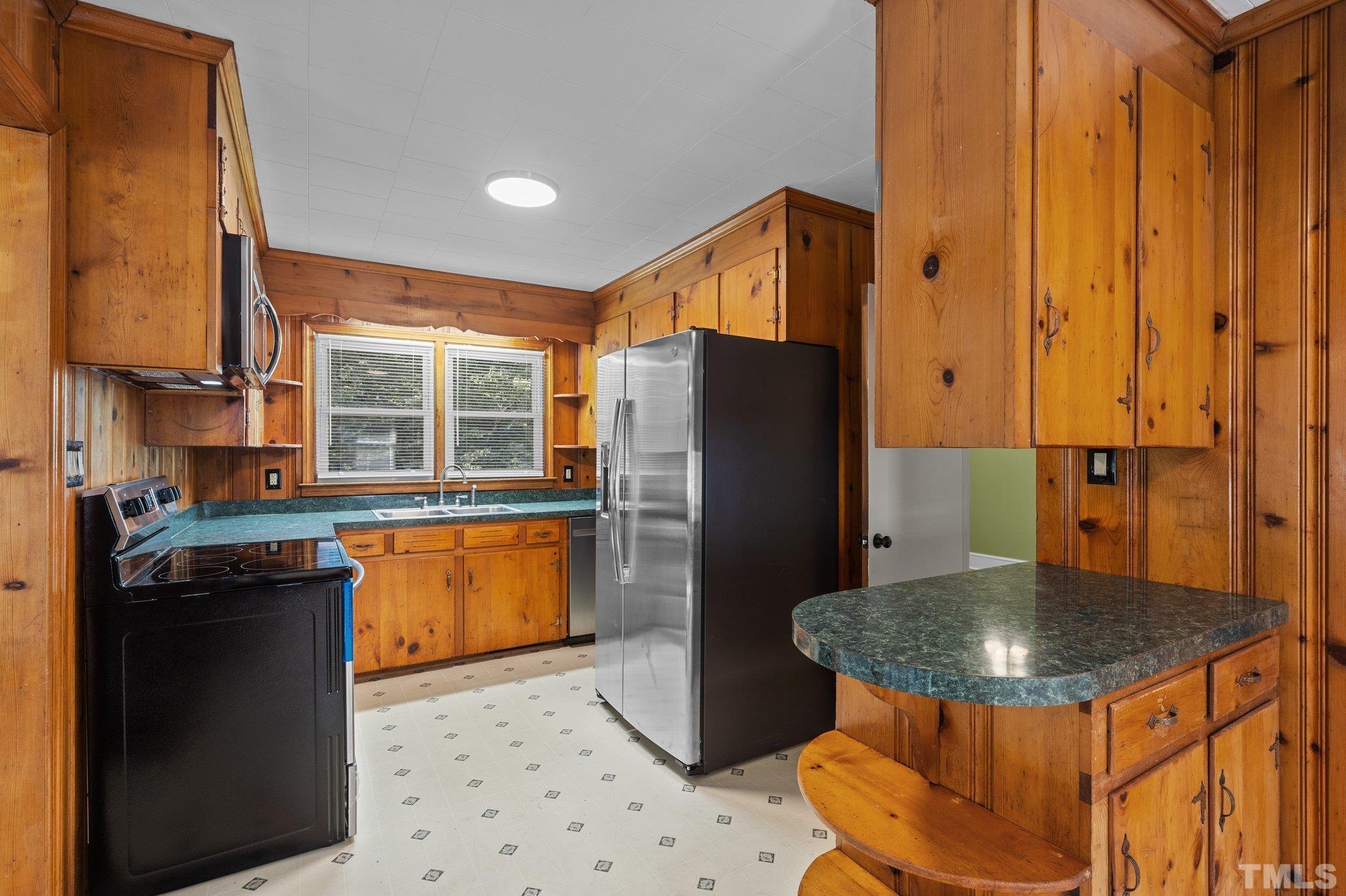 3645 Hicksboro Road Henderson, NC 27537 - Photo 12 of 37 a kitchen with a refrigerator a sink and a stove