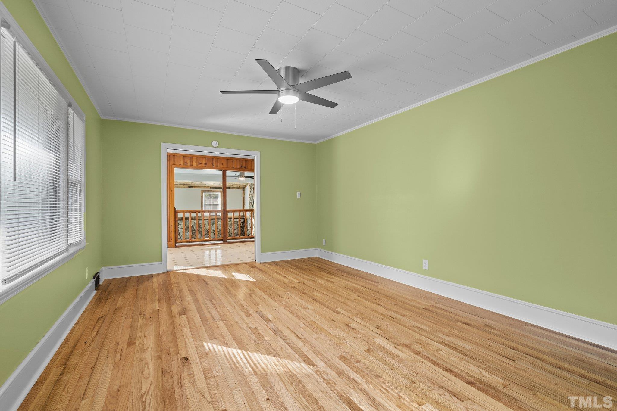 3645 Hicksboro Road Henderson, NC 27537 - Photo 18 of 37 a view of an empty room with wooden floor and a window