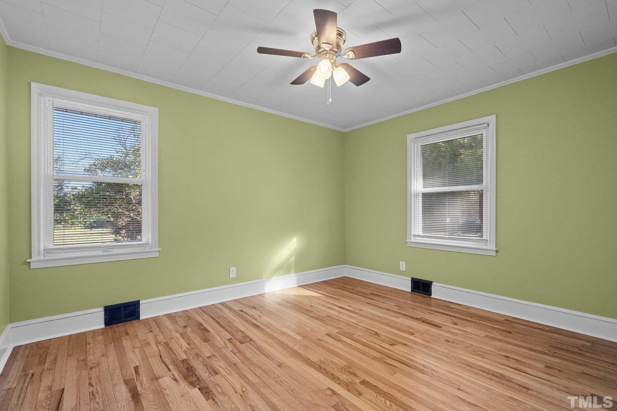 3645 Hicksboro Road Henderson, NC 27537 - Photo 20 of 37 a view of empty room with wooden floor and fan