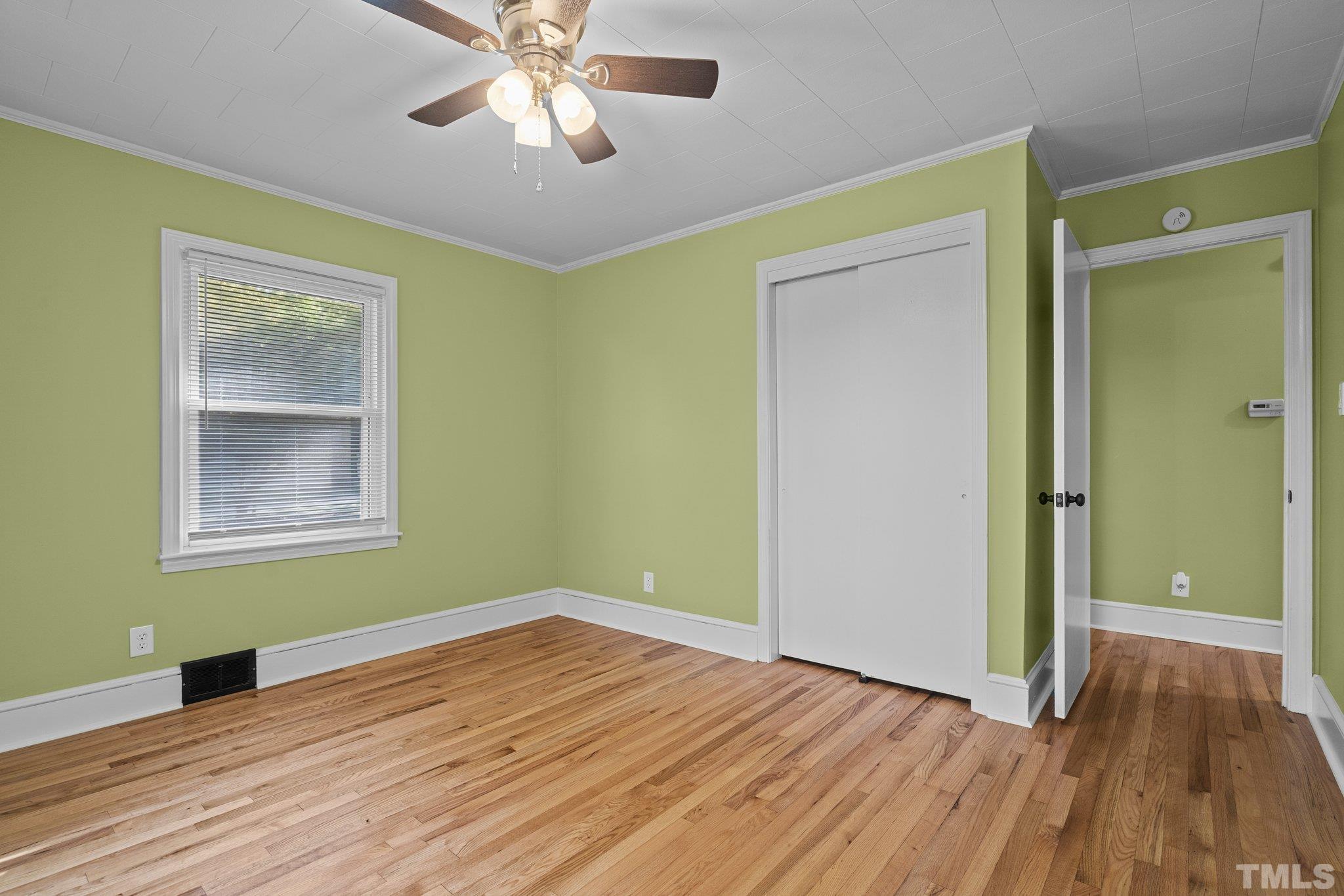 3645 Hicksboro Road Henderson, NC 27537 - Photo 21 of 37 wooden floor in an empty room with a window