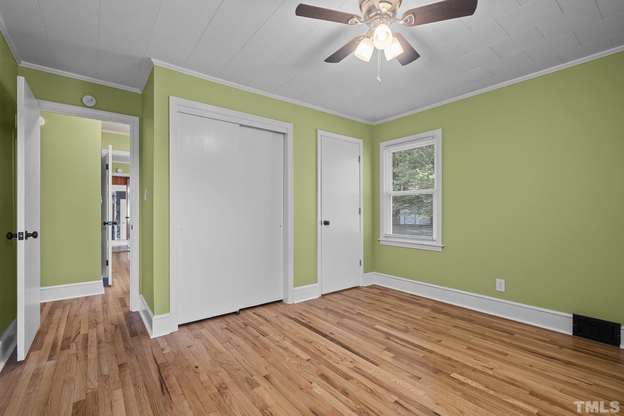 3645 Hicksboro Road Henderson, NC 27537 - Photo 23 of 37 wooden floor in an empty room with a window