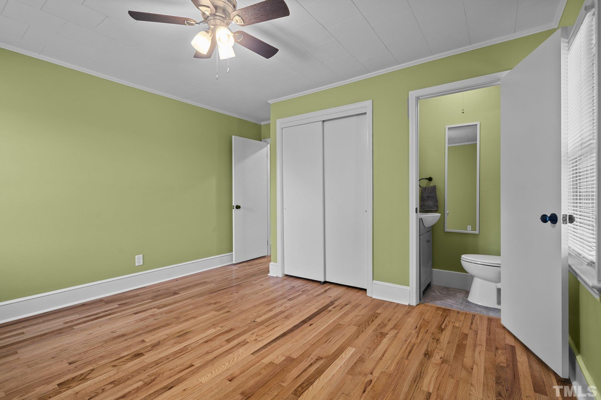 3645 Hicksboro Road Henderson, NC 27537 - Photo 24 of 37 a view of a room with wooden floor and a ceiling fan