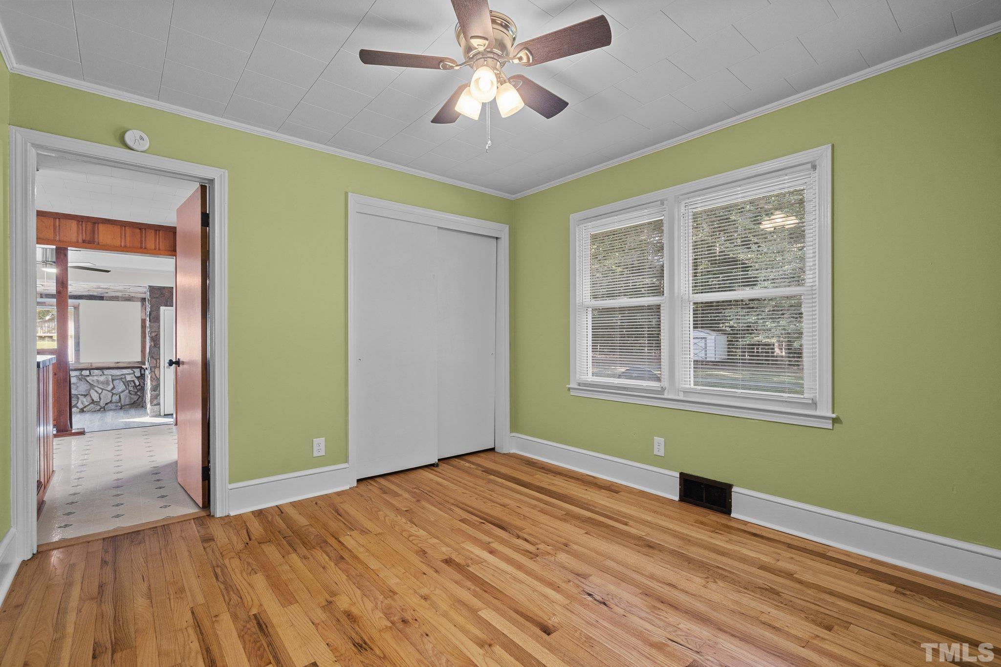 3645 Hicksboro Road Henderson, NC 27537 - Photo 27 of 37 a view of empty room with wooden floor and fan