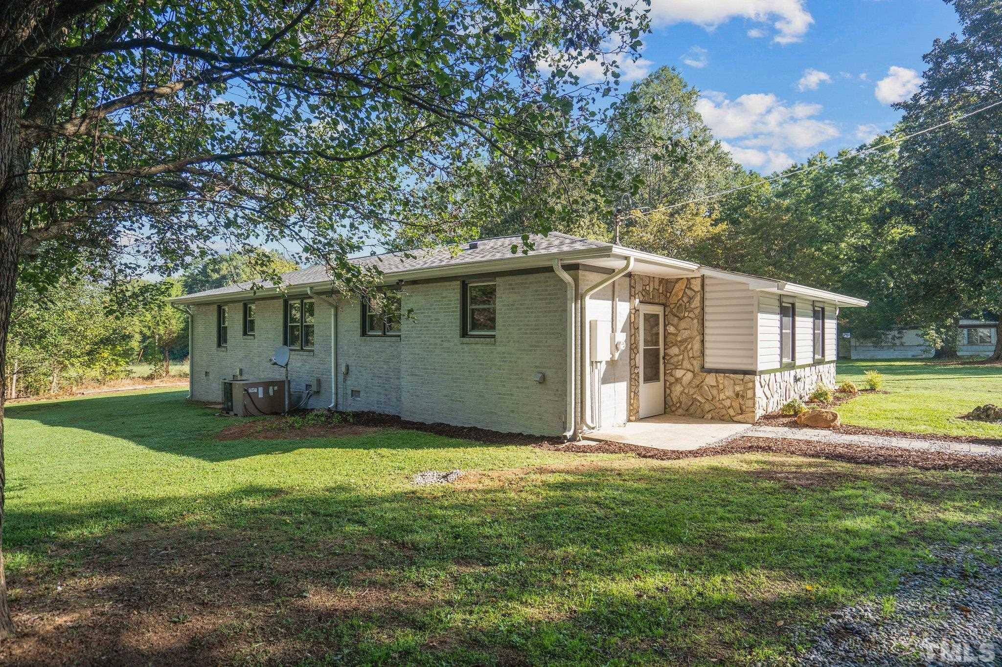 3645 Hicksboro Road Henderson, NC 27537 - Photo 33 of 37 a view of a house with a yard and a large tree