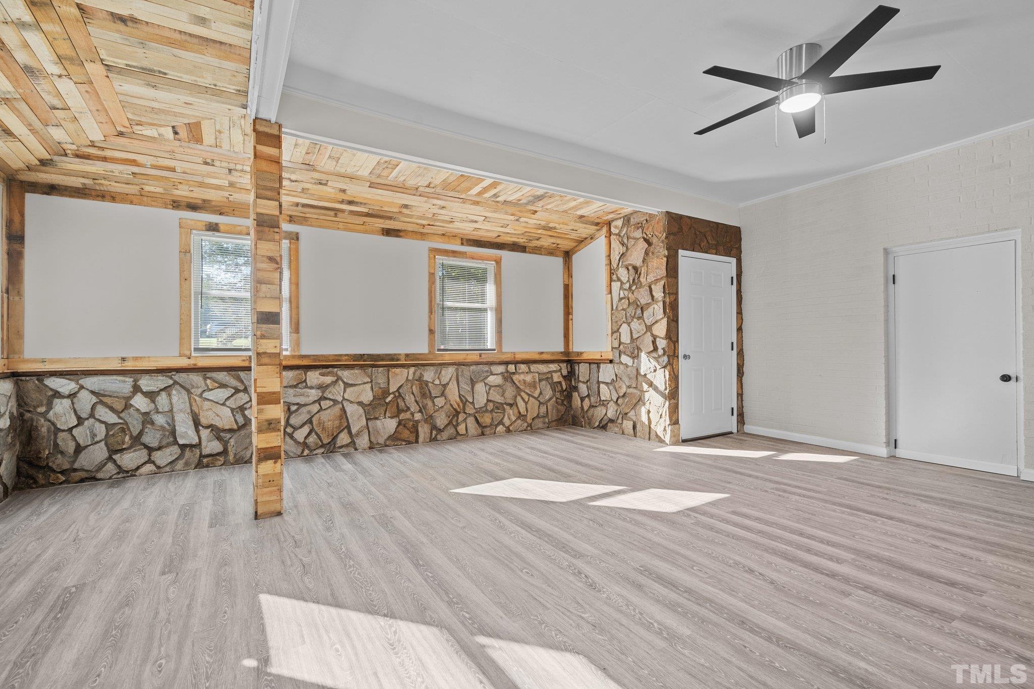 3645 Hicksboro Road Henderson, NC 27537 - Photo 6 of 37 a view of a livingroom with wooden floor and a ceiling fan
