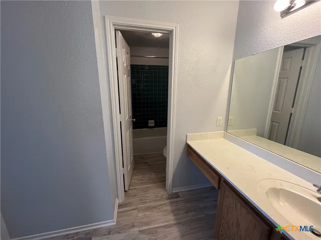 a bathroom with a sink a toilet and bathtub