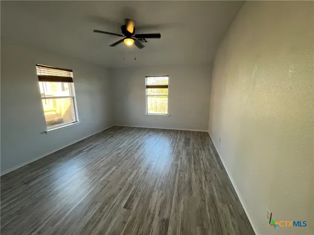 a view of hallway with wooden floor
