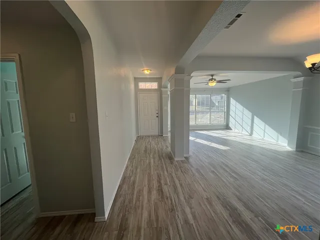 a view of hallway with wooden floor