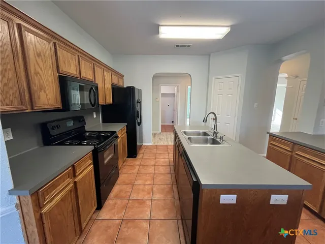 a kitchen with a sink and a refrigerator