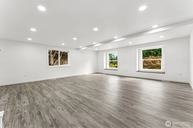 an empty room with windows and entrance