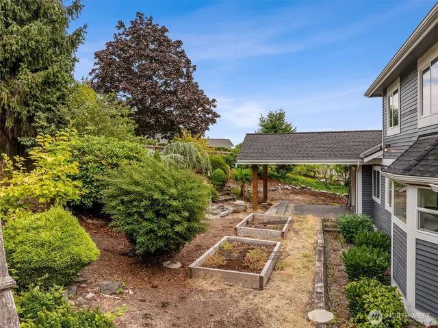 a backyard of a house with table and chairs