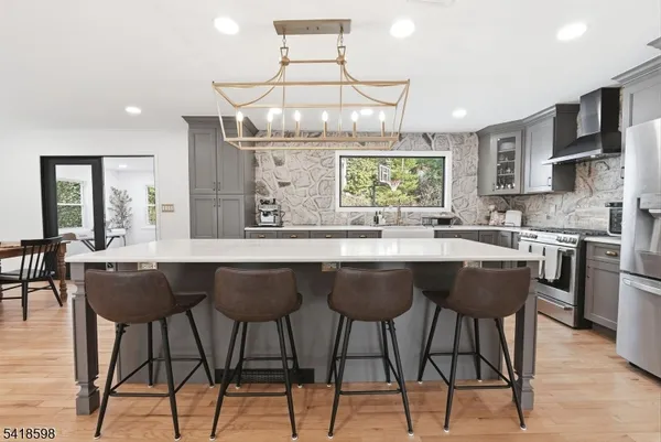a kitchen with a table chairs sink and cabinets
