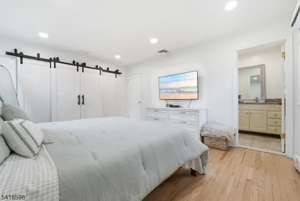 a bedroom with a bed and a view of kitchen