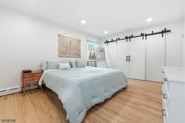 a bedroom with a bed and a chair