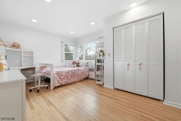 a bedroom with furniture and a wooden floor