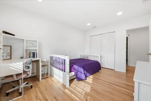 a bedroom with a bed and a chair