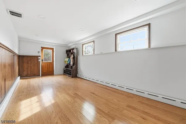 a view of empty room with wooden floor