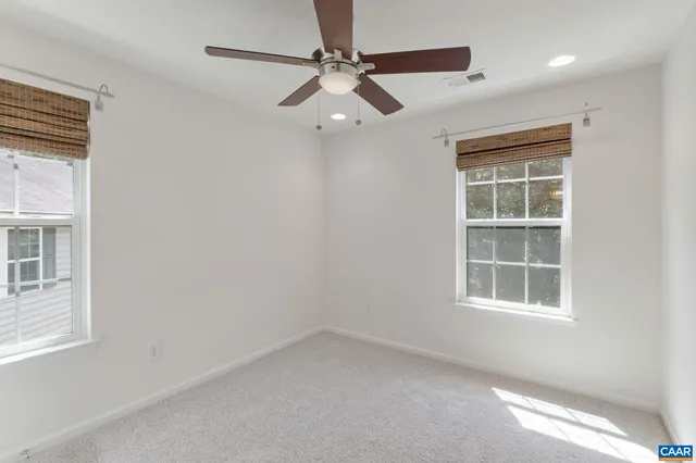 a view of a room with a ceiling fan and a window