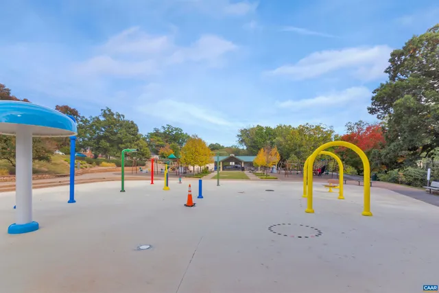 a view of park with swings and slides