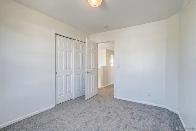 an empty room with closet area