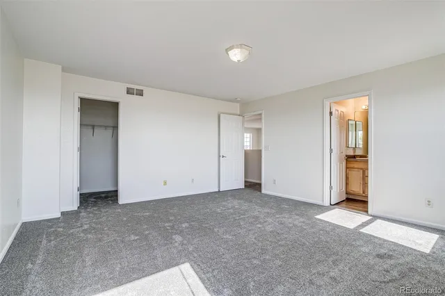 a view of an empty room and closet area