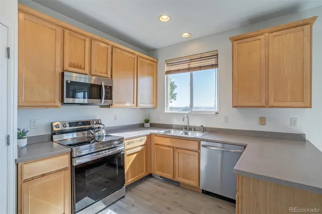 a kitchen with sink cabinets and stainless steel appliances