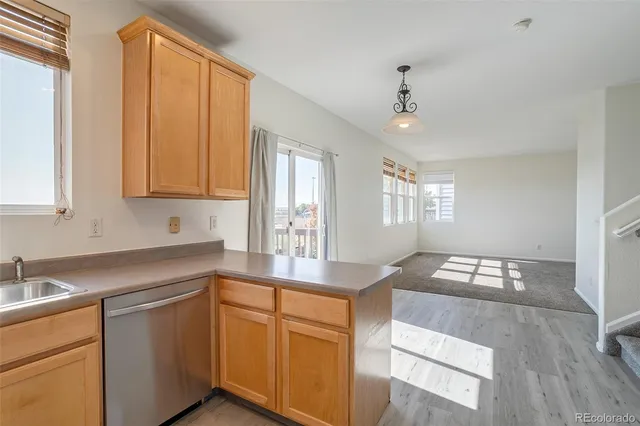a kitchen with cabinets appliances and a window