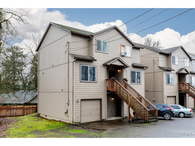 a view of a white house with large windows