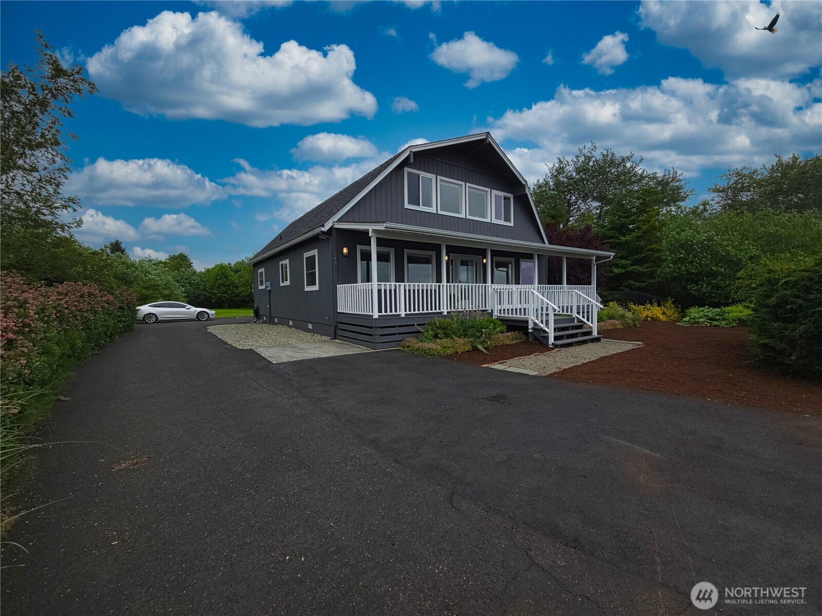 240 Stringtown Road Ilwaco, WA 98624 - Photo 1 of 39 a view of a house with a yard and lake view