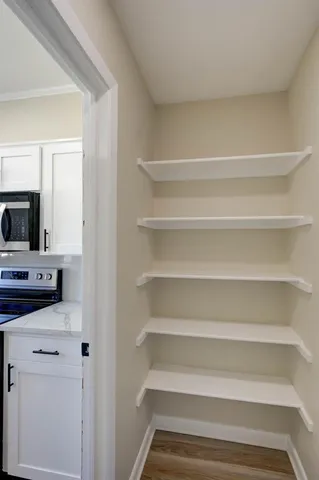 a view of walk in closet with empty racks