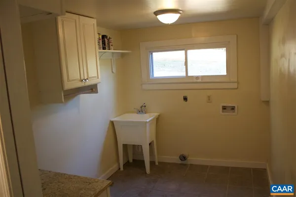 a view of a hallway with wooden floor and entryway