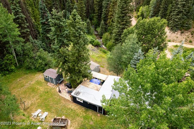 a view of a yard with chairs