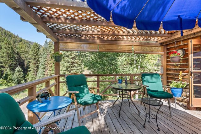 a view of a chairs and table in patio with potted plants