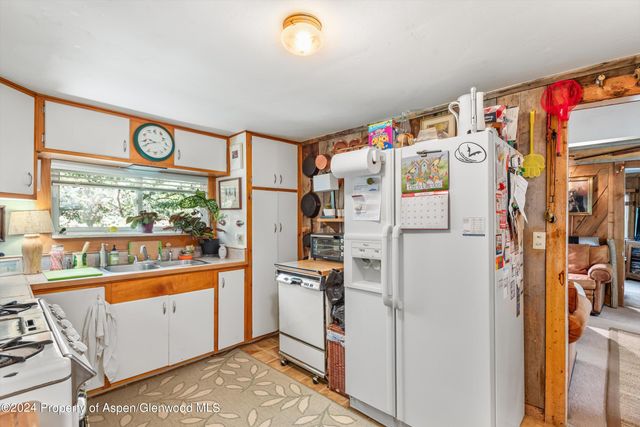a white refrigerator freezer sitting inside of a kitchen